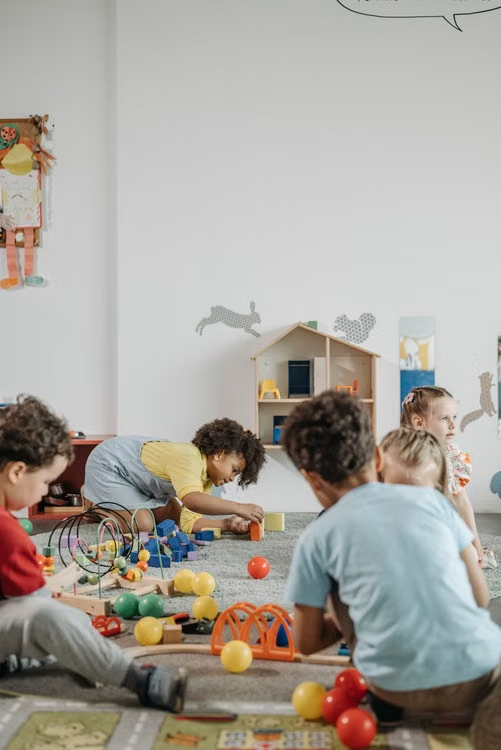 Children playing together with toys in a bright, welcoming daycare space